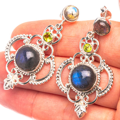 Sterling silver drop earrings with blue labradorite, green peridot, and ornate filigree.