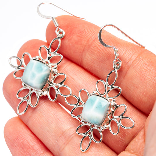 Sterling silver dangle earrings with square light-blue larimar stones and floral cutout frames