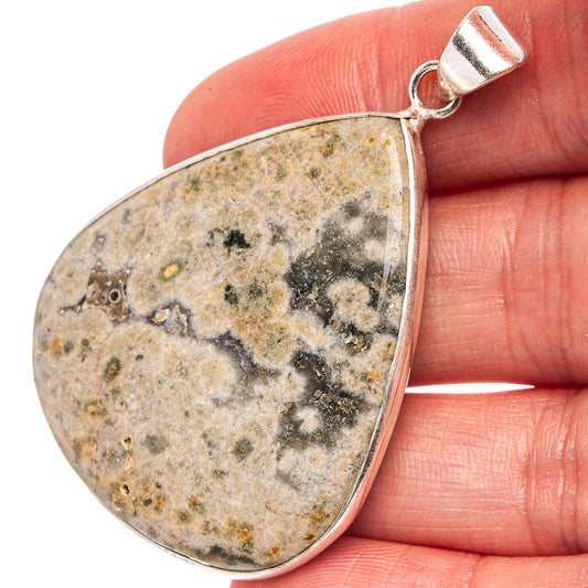 Ocean jasper teardrop pendant with silver-plated bail, speckled stone.