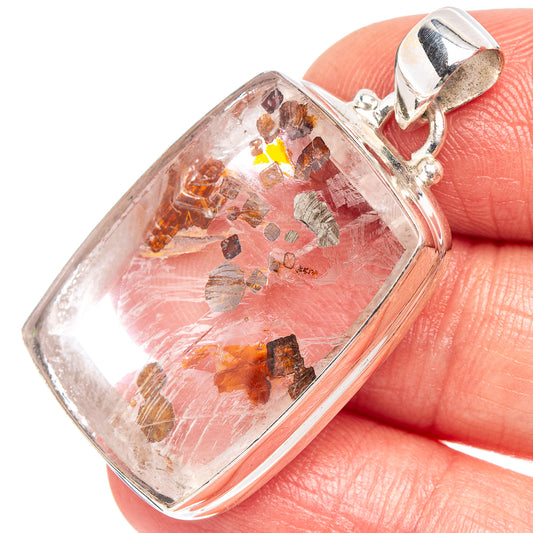 Marcasite quartz pendant close-up: clear square cabochon with orange-brown flecks, silver bail