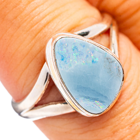 Sterling silver opal ring with oval blue doublet gemstone, detailed bezel setting