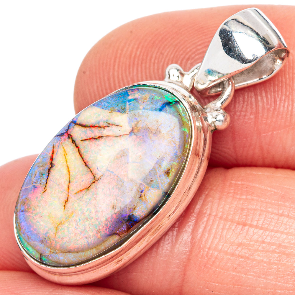 Sterling silver opal pendant with oval multicolor stone and hinged bail, close-up