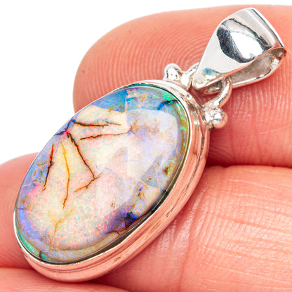 Sterling silver opal pendant with oval multicolor stone and hinged bail, close-up