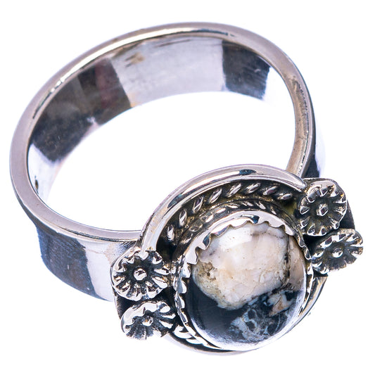Silver adjustable band ring with oval white-and-dark stone and flower-shaped side accents