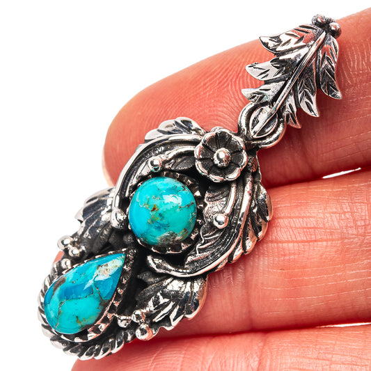 Sterling silver turquoise pendant with two cabochon stones and leaf filigree details