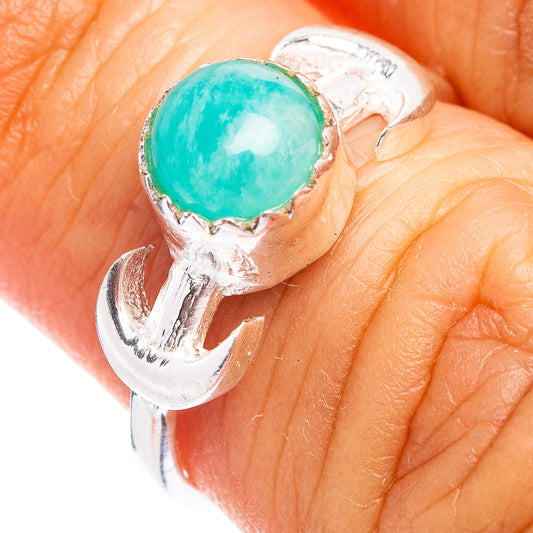 Amazonite dainty ring with oval turquoise stone in silver setting on finger
