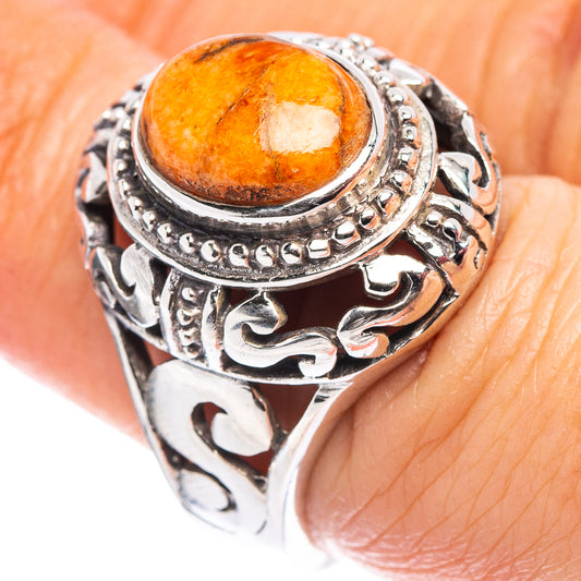 Sterling silver filigree ring with oval orange cabochon coral, size 6.75.
