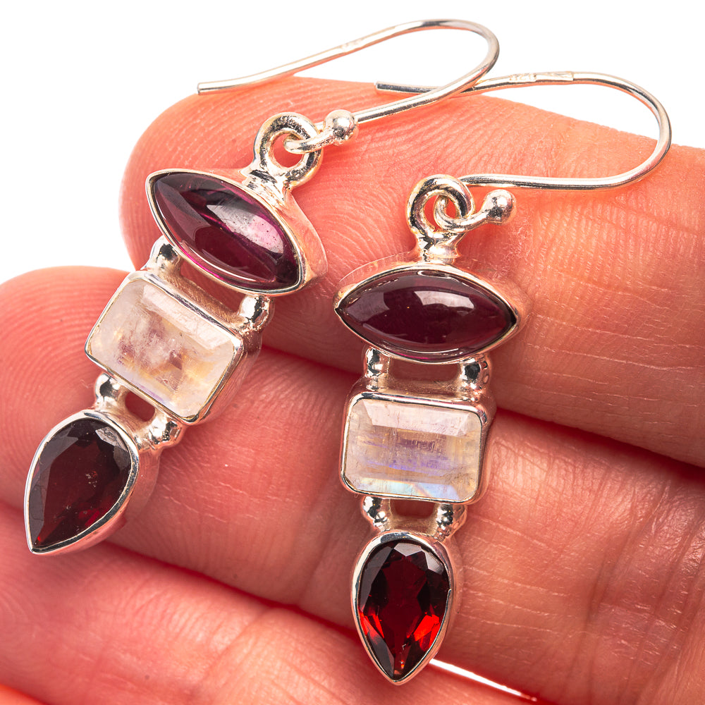 Sterling silver drop earrings with dark red oval stones, iridescent squares, and pink accents