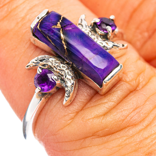 Purple amethyst-style gemstone ring with silver-tone settings and floral side details