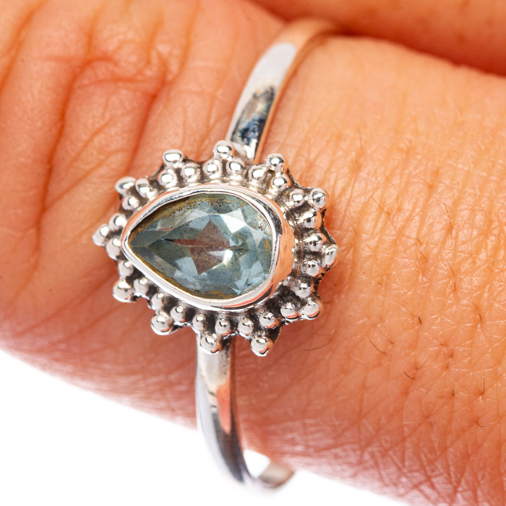 925 sterling silver dainty ring with oval blue topaz and clustered halo detail