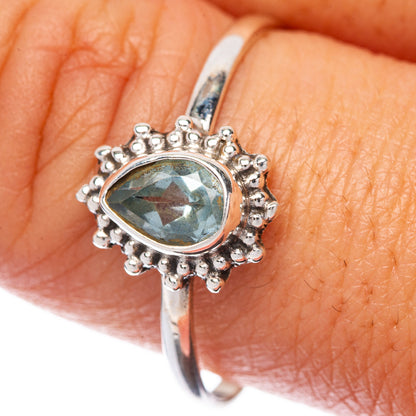 925 sterling silver dainty ring with oval blue topaz and clustered halo detail