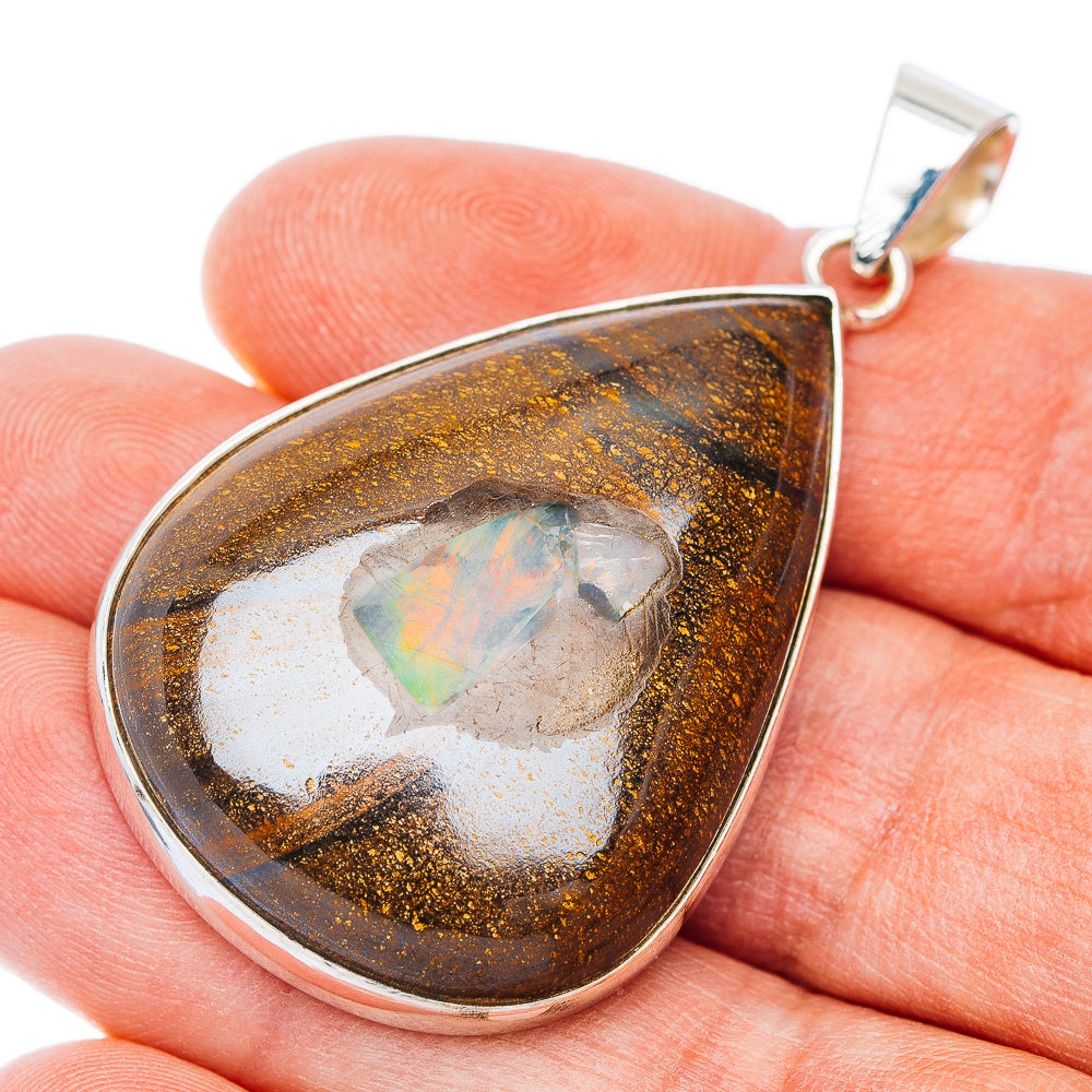 Teardrop boulder opal pendant in .925 sterling silver bezel with loop bail