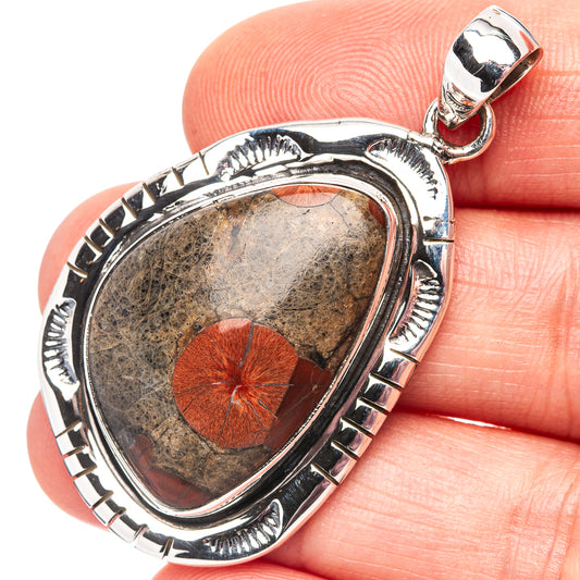 Sterling silver peanut obsidian pendant with red petal-like center in ornate frame