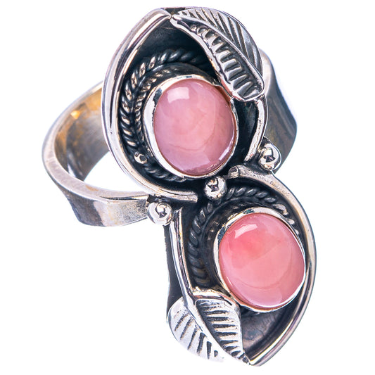 Oval pink opal cabochon adjustable .925 sterling silver ring, openwork side details.