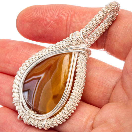 Silver-plated wire-wrap teardrop agate pendant with banded brown and amber stone