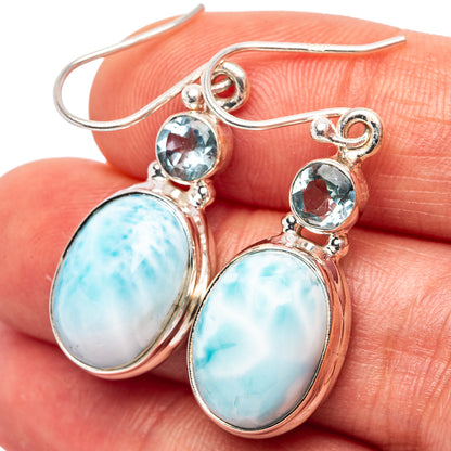 Sterling silver drop earrings with oval blue larimar and round blue topaz accents