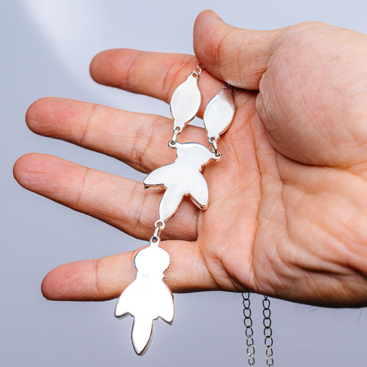 Sterling silver pendant necklace with three dangling leaf-shaped charms