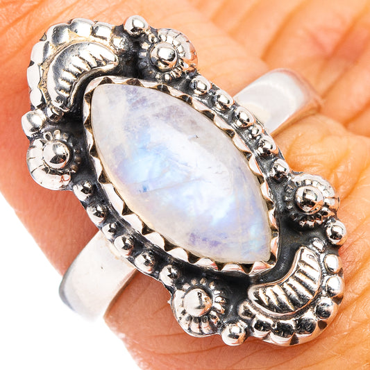 Silver-tone oval moonstone ring with ornate beaded bezel and scalloped band detail