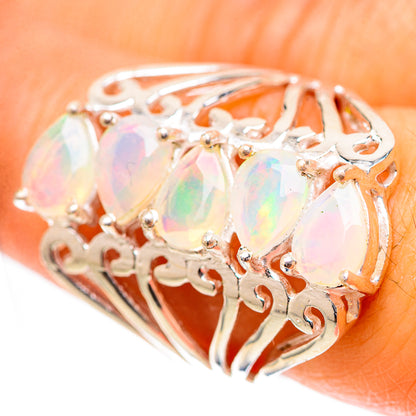 Opal ring in sterling silver with faceted oval stones and decorative filigree, size 7.25.