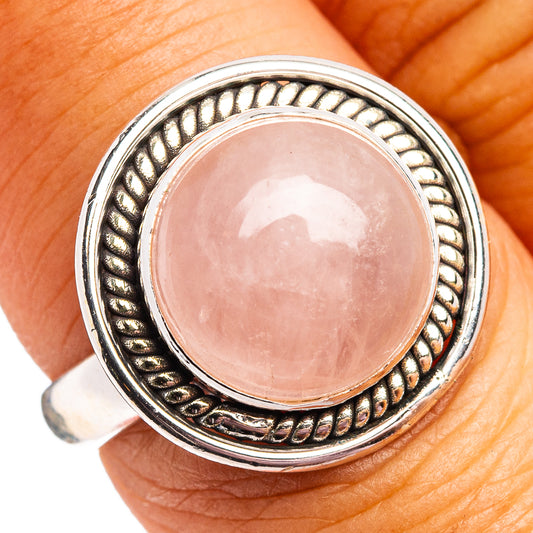 Rose quartz cabochon sterling silver ring with textured bezel and round stone