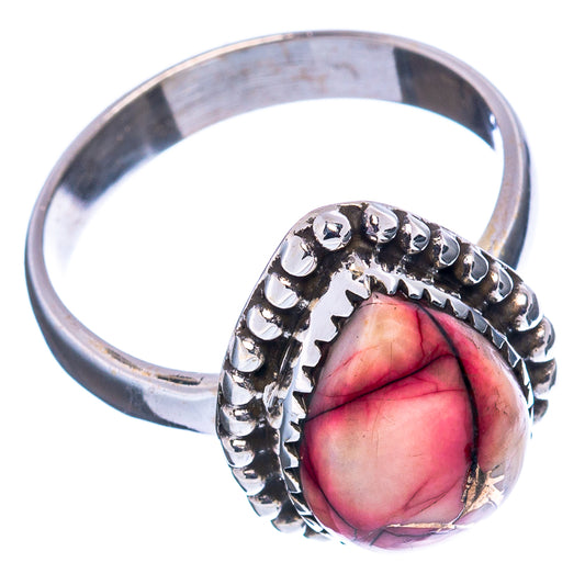 Sterling silver ring with oval red-pink stone, raised bead band detail