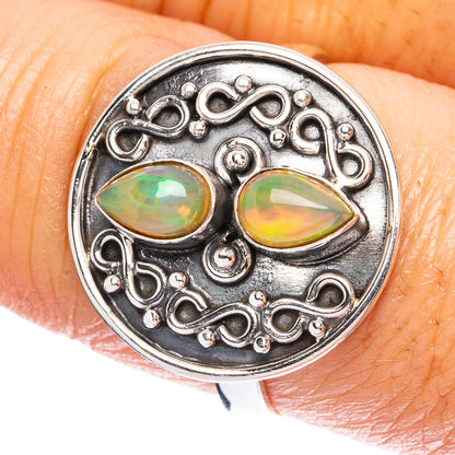 Sterling silver filigree ring with two oval Ethiopian opal stones, green and orange flashes.