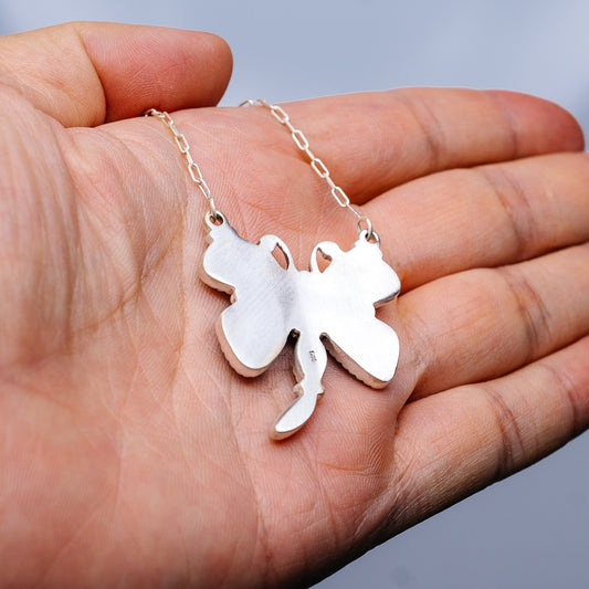 Sterling silver butterfly pendant necklace held in hand