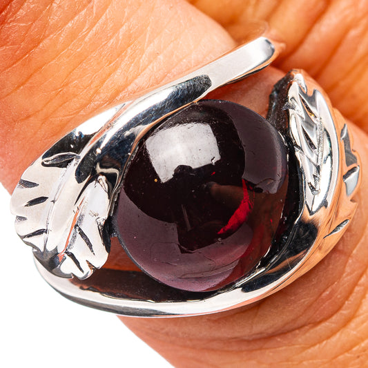 Sterling silver garnet ring with dark red teardrop gemstone, sculpted band