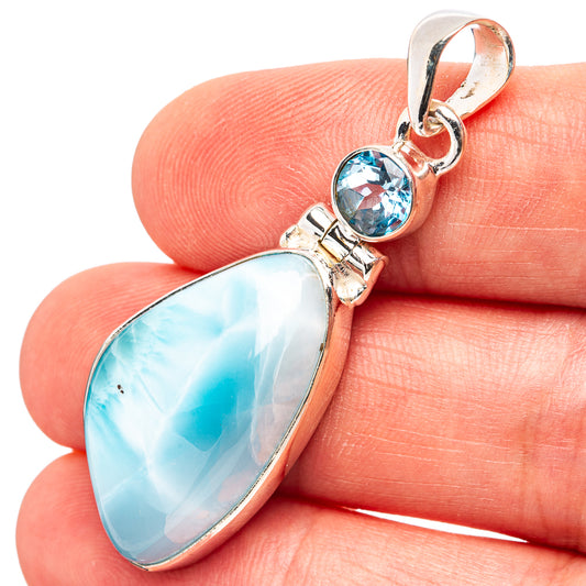 Sterling silver pendant with oval light blue larimar and round blue topaz accents