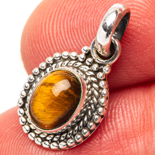 Sterling silver tiger's eye pendant with oval cabochon and beaded frame