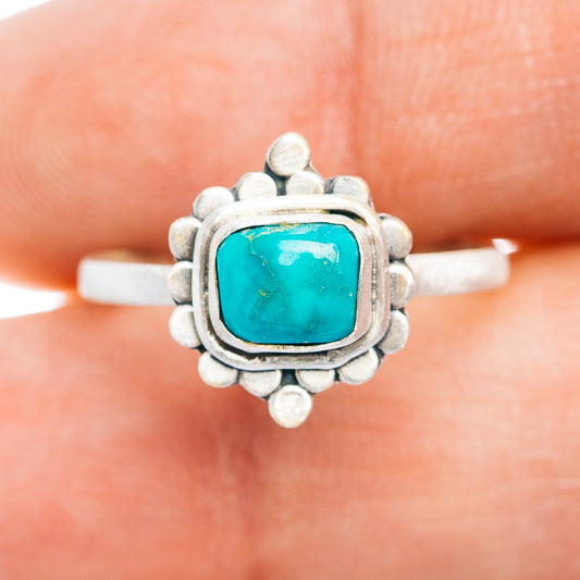 Sterling silver turquoise ring with square cabochon and raised bead border, size 8