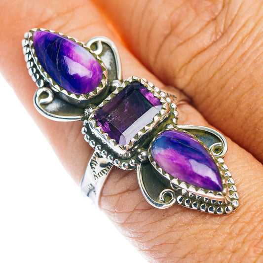Sterling silver ring with three purple stones and ornate Southwestern-style settings