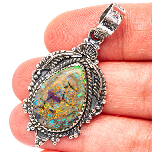 Sterling silver oval opal pendant with ornate leaf and rope bezel