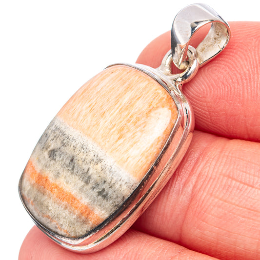 Sterling silver pendant with orange-gray cabochon stone and polished loop bail.