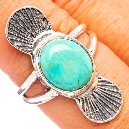 Sterling silver turquoise oval ring with engraved leaf bands, size 8, on hand