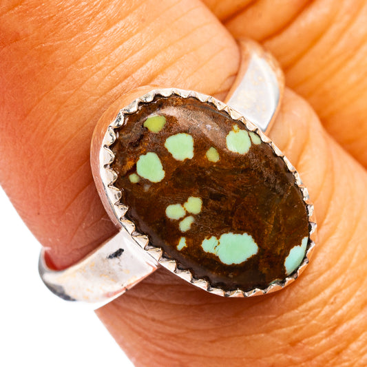 Oval turquoise bezel ring on .925 sterling silver band, mottled light-green stone inlay.