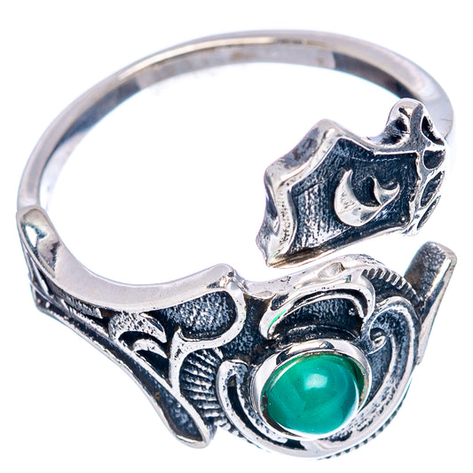 Sterling silver ring with green oval cabochon and raised filigree scrollwork design