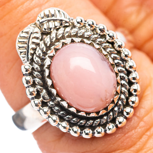 Pink opal sterling silver ring with oval pink cabochon and beaded halo design