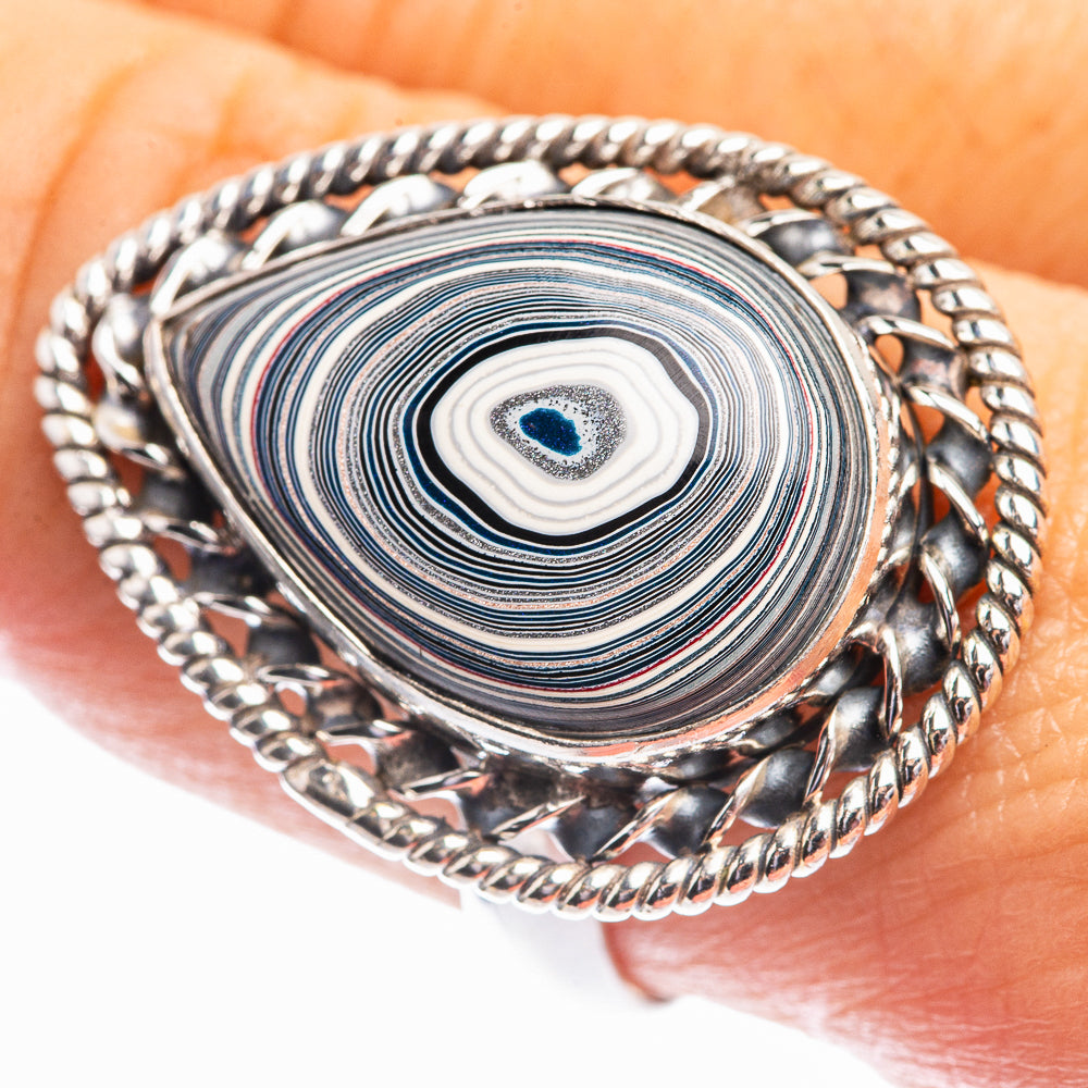 Oval sterling silver ring with blue-gray swirl stone and braided rope edge