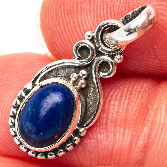 Oval lapis lazuli pendant in .925 sterling silver with ornate openwork bail and border