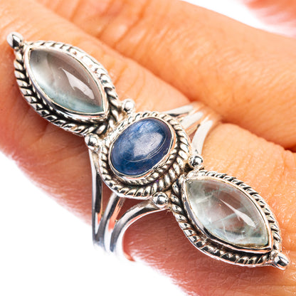 Silver ring with three oval blue stones in ornate rope-edged settings