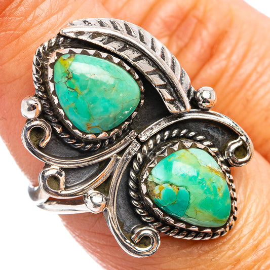 Turquoise cabochon ring with ornate sterling-silver setting and two green stones