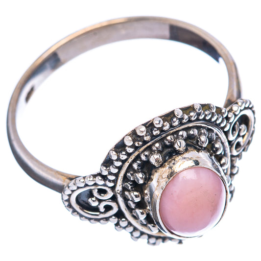 Pink opal sterling silver ring with ornate halo setting and oval pink gemstone