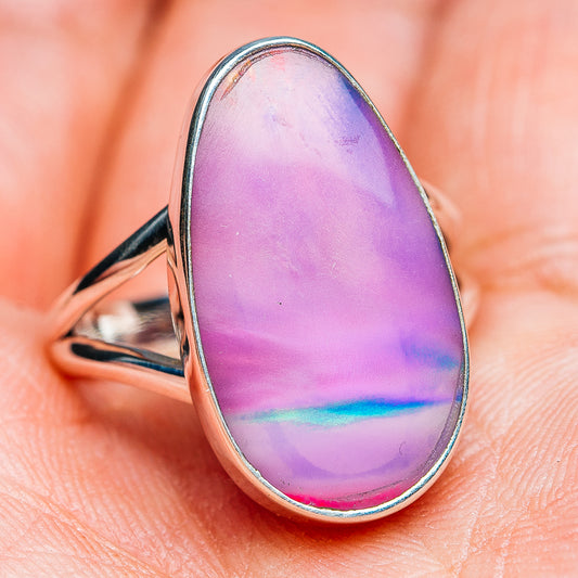 Teardrop opal ring with iridescent pink-purple center set in silver-toned band