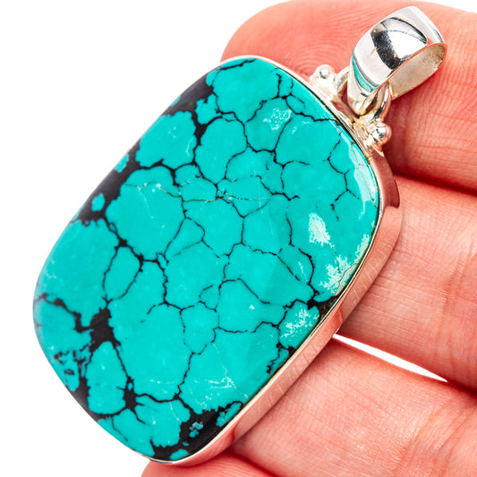 Turquoise pendant with oval gemstone and sterling silver bezel, hinged bail