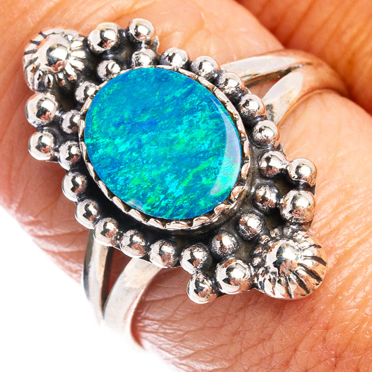 Sterling silver opal ring close-up with round blue-green center and bead surround