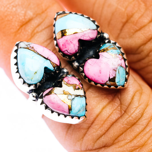 Heart-shaped multi-stone ring with turquoise, pink, and gold accents on dark setting