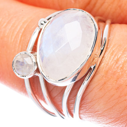Oval moonstone sterling silver ring with a small round accent stone, oval center setting