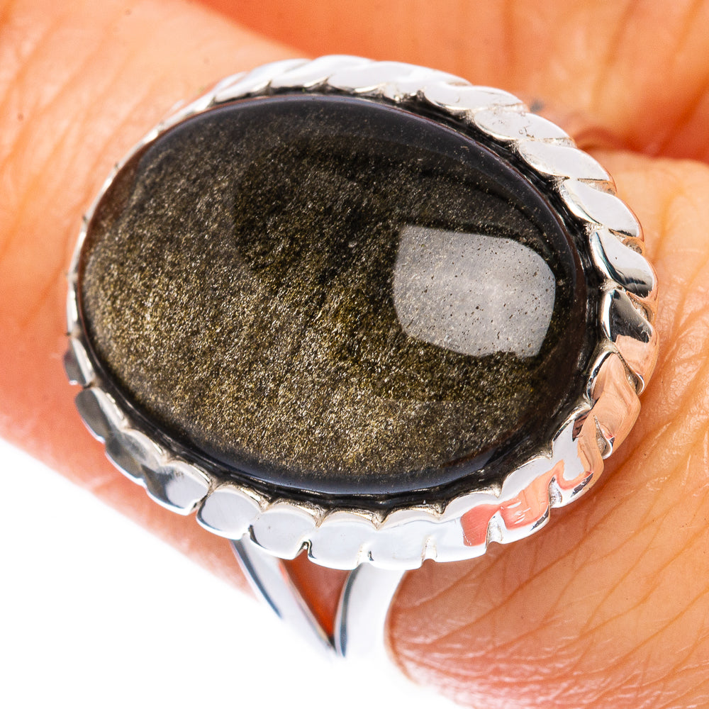 Oval dark obsidian ring with silver bezel and raised decorative side details