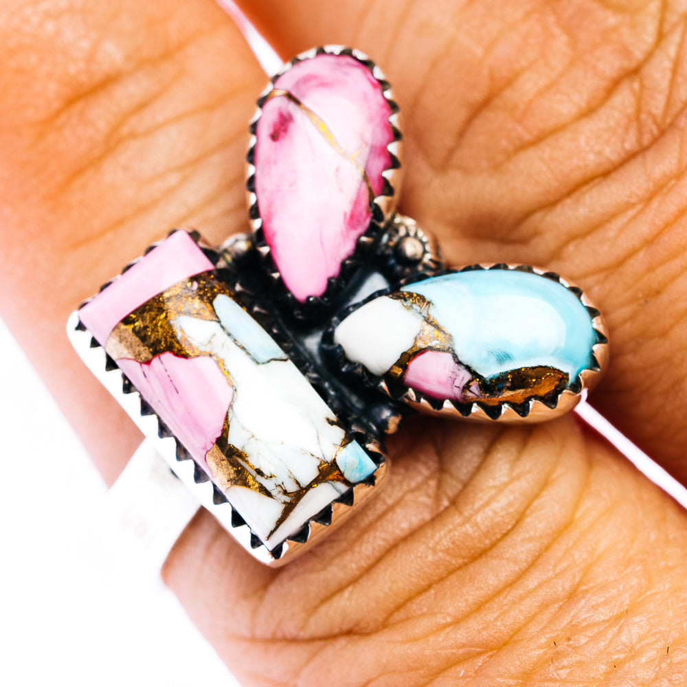 Southwestern-style ring with pink and turquoise teardrop stones in a black bezel setting